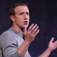 Mark Zuckerberg, META CEO, holds his hands up as he speaks to an audience.